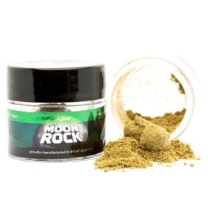 Premium Northern Lights Moon Rocks coated in golden kief on a wooden table.